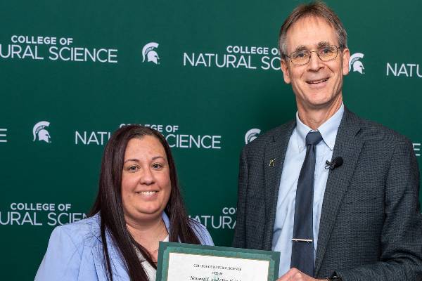 Dean Eric Hegg awards Prof. Rachel Henderson the College's Excellence in Teaching Award